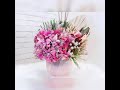 Glass arrangement with artificial mixed with cap mixed and dried flowers