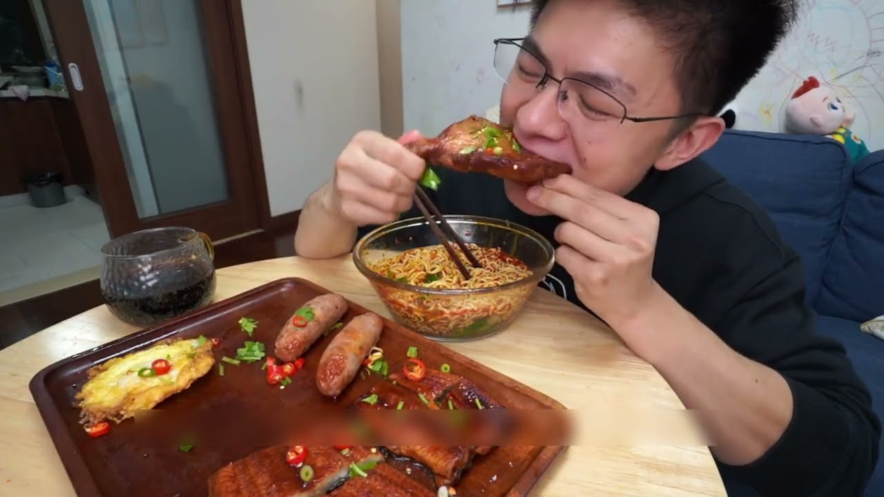 Two packs of instant noodles, plus eel, grilled sausage, fried egg,