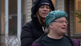 Minnesotans stand on balconies and porches to sing