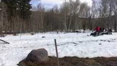 How to load a snowmobile onto a trailer.