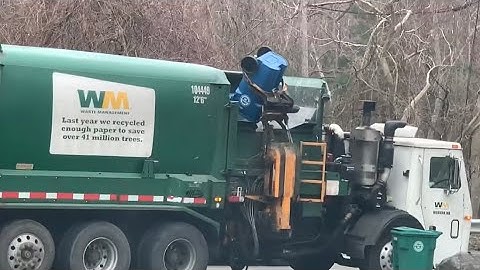 Waste management Mack LEU labrie garbage truck collecting trash.