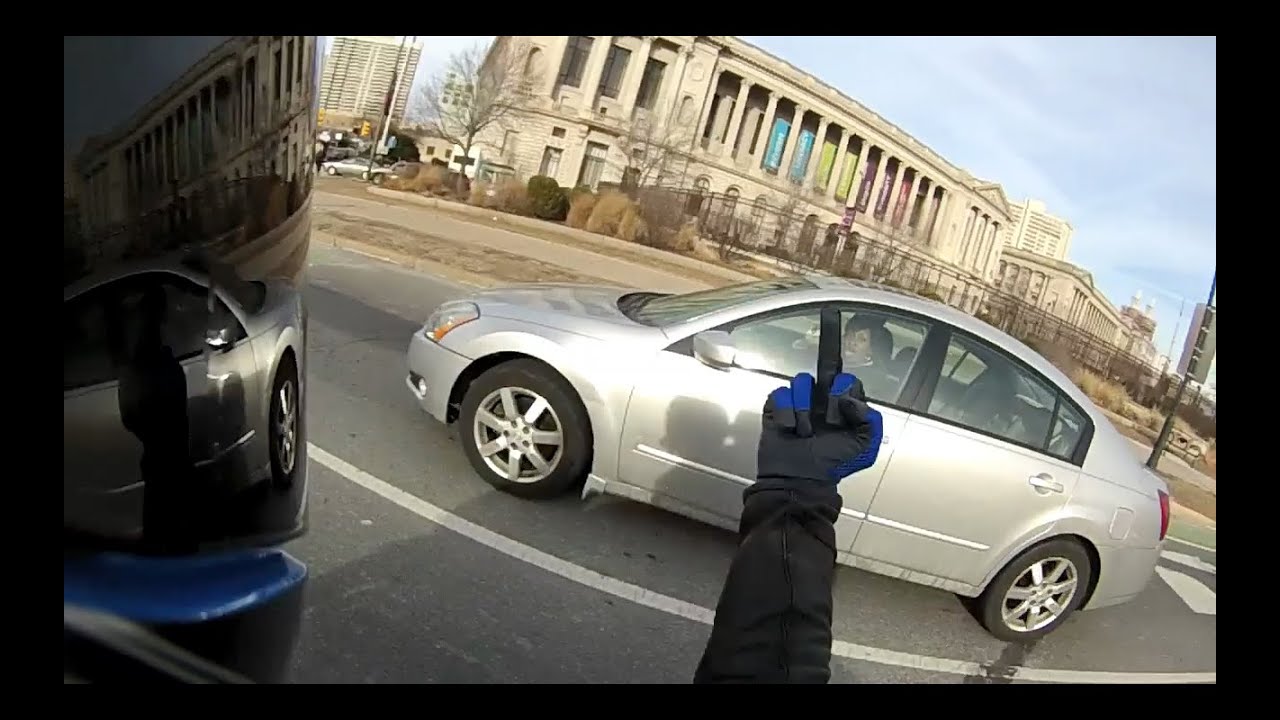 Biker almost hit by car