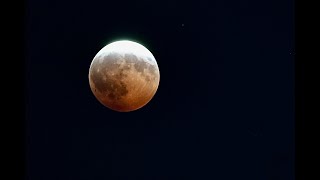 Partial lunar eclipse seen over downtown Portland