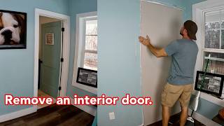 Remove an interior door and cover the doorway with drywall.