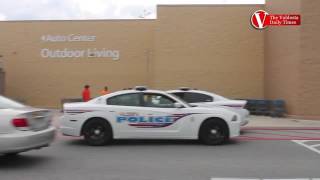 Police cars and an ambulance wait outside the Walmart on Inner Perimeter Road in Valdosta, Ga., Thur