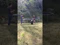 Two middle schoolers sword fighting in my backyard