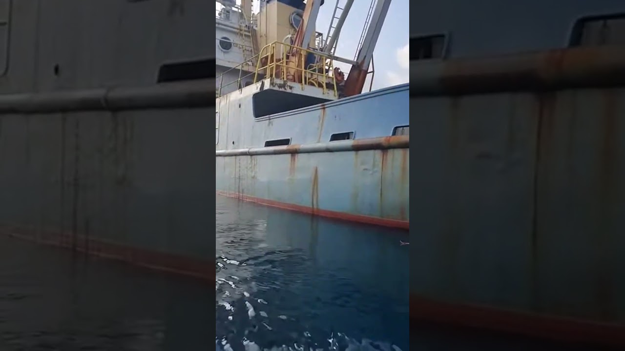 Documentary-style footage capturing waste drifting into open water from an aging research ship