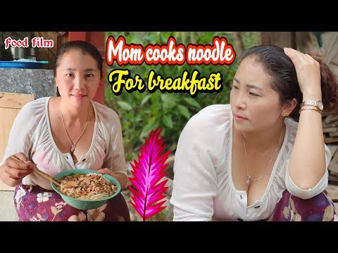 Mom cooks noodle for breakfast