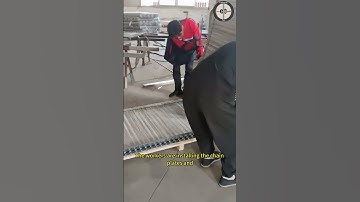 The workers are installing the chain plates and assembling them into a conveyor belt