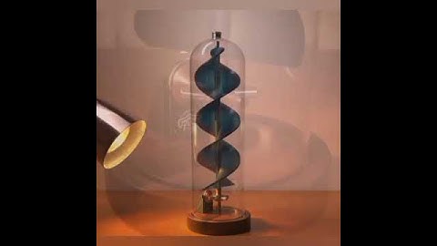Light powered kinetic sculpture with translational motion due to rotation of a spiral under glass