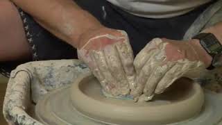 Compressing The Bottom Of A Clay Pot On The Pottery Wheel