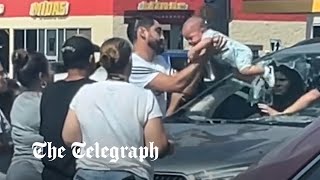 video: Watch: Man smashes windscreen to save baby from heat death