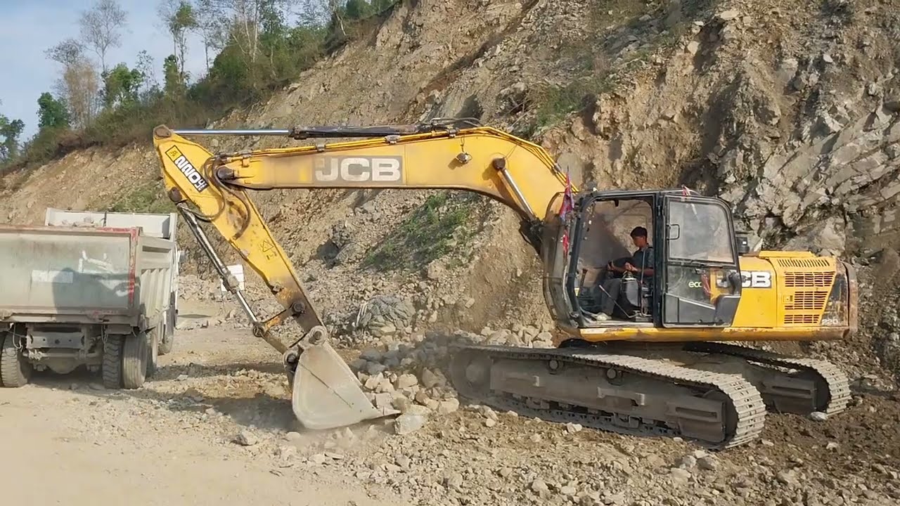 Jcb loading stone in truck - JCB Video - JCB 220 LC 