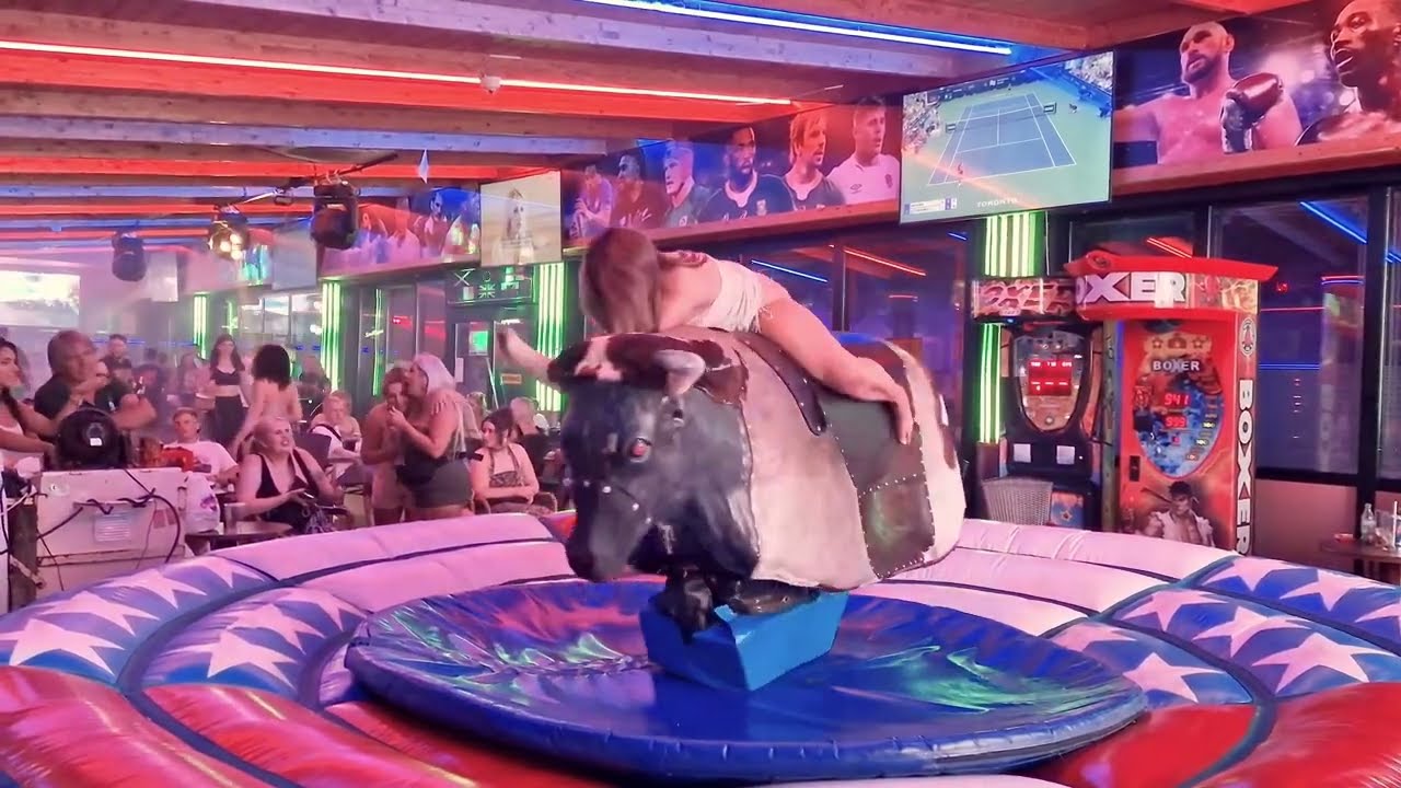 🔥 Stunning Girl in White Dress Rides Wild Mechanical Bull in Benidorm! 🇪🇸 | Must-See Action!
