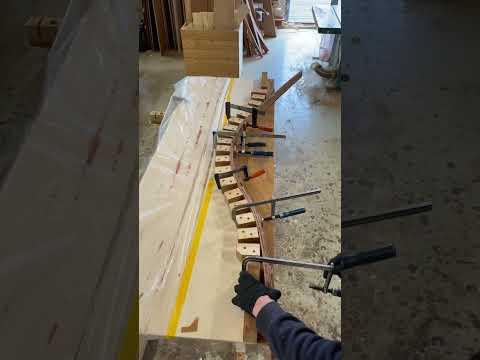 Laminating mahogany bench front.