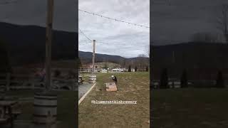 Dad plays bean bag toss game with son and boy gets hit with bean bag sack