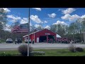 Flag flying at half staff while some 50 people gather at the Morrill Volunteer fire station