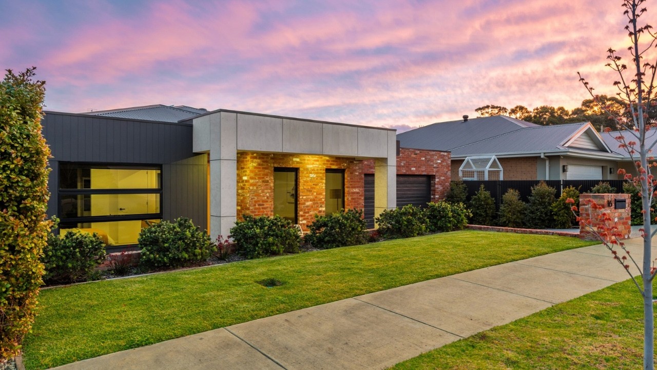 Contemporary single storey home with brick and concrete facade photographed at dusk at 16 Brooklyn Drive, Golden Square