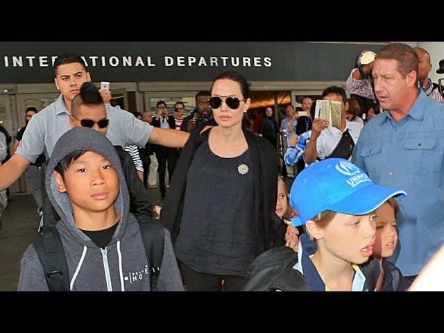 Angelina Jolie and her son Maddox Jolie-Pitt arriving at LAX, wearing  leather leggings and carrying a Louis Vuitton bag Featuring: Angelina Jolie,Maddox  Jolie-Pitt Where: Los Angeles, California, United States When: 13 Apr