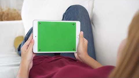 Young asian woman using black tablet device with green screen    Free HD Video Clips