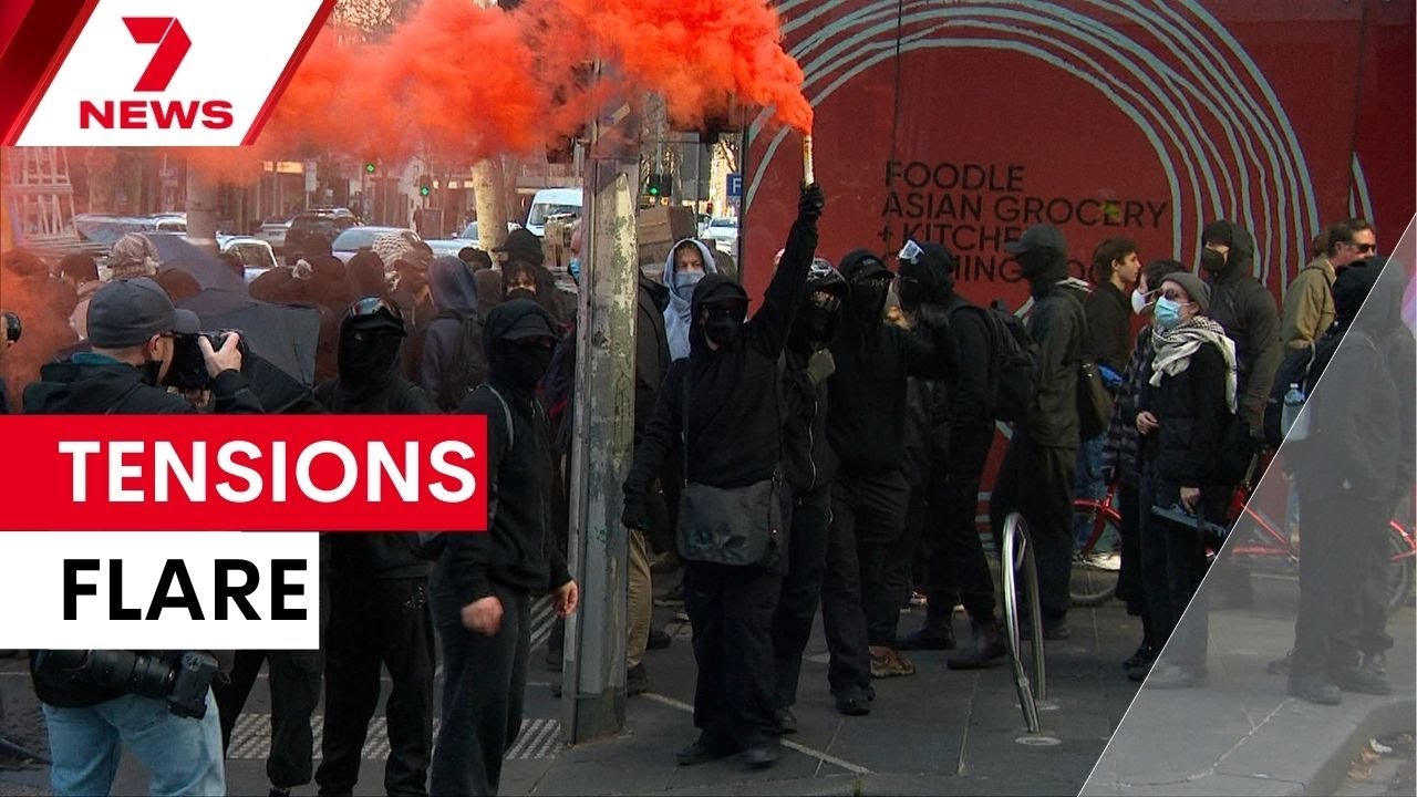 Police officers injured trying to keep the peace between feuding protest groups in the city | 7NEWS