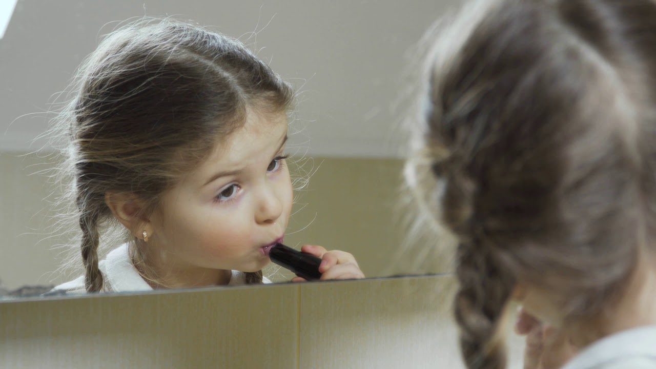 Little girl paint her lips with lipstick YouTube