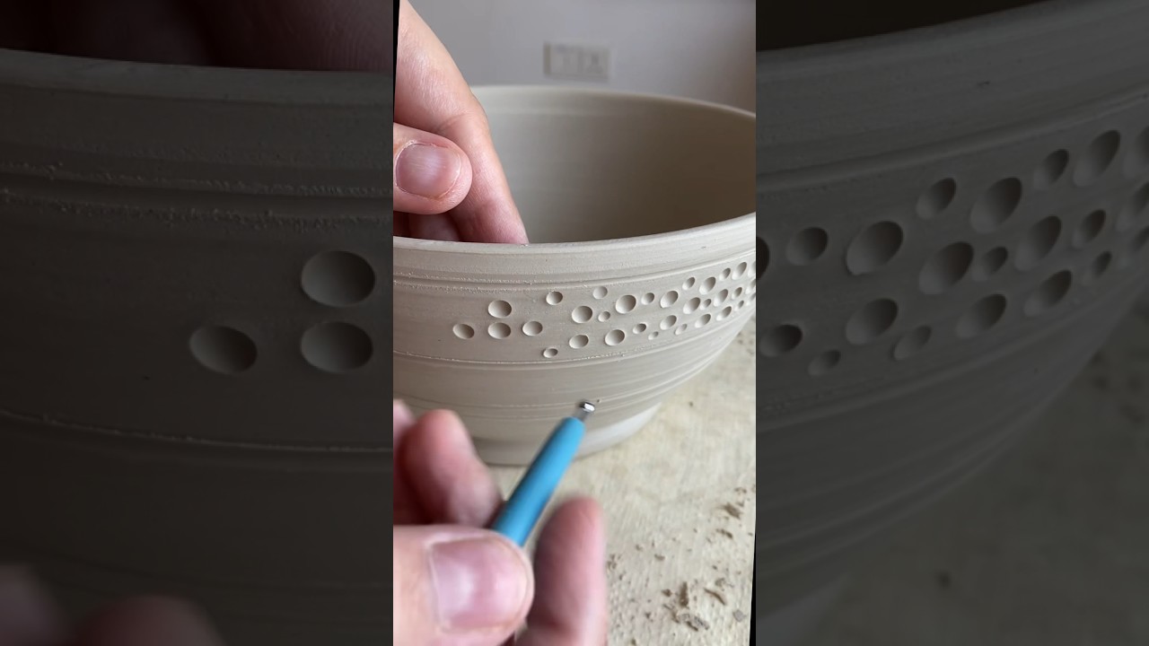 Trimming and decorating a new ceramic fruit bowl. 
