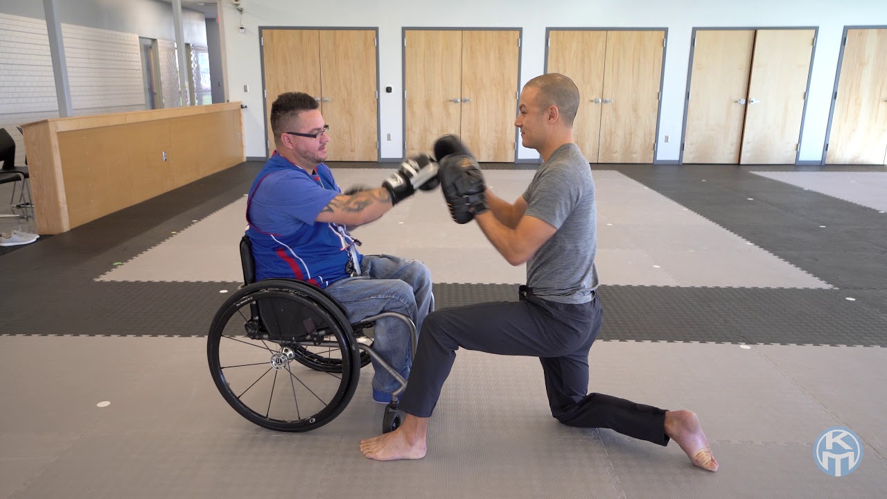 Master Ko leads a boxing lesson with a chair user at KOMA YouTube