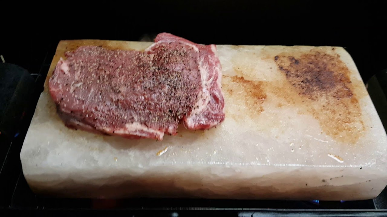 Ribeye cooking on a Himalayan salt block with a Walmart camp stove