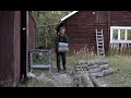 Making fire wood  - log cabin in Sweden, axe and chain saw