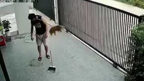 man forget his broom in his armpit and searching around for it