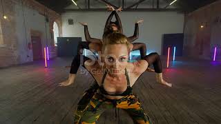 Women dancing in studio. Synchronized choreography  Sunbeams on the floor, windowframe shadows