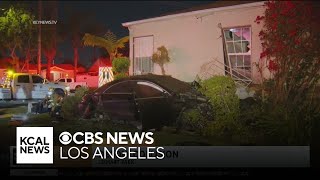 Fiery two-car crash leaves one dead after one car crashes into a West Adams home