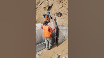 Workers use plywood to do formwork for manhole