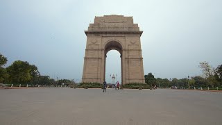 Low angle timelapse shot of people's activity at India gate in New Delhi on a rainy day