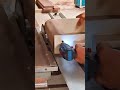 cutting a thick wooden log into a smooth semi cylindrical piece using a specialized table saw blade