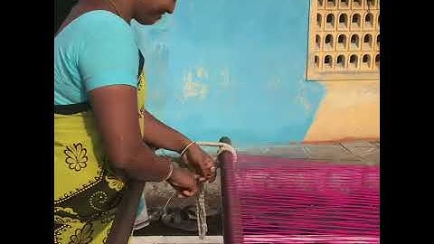 The threads that bind: A weaver named Priya carefully tying each individual thread.
