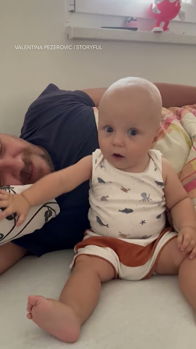 Baby can't believe the depth of dad's 'snoring'