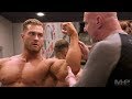 Chris Bumstead bodybuilding posing instruction with IFBB head judge Steve Weinberger