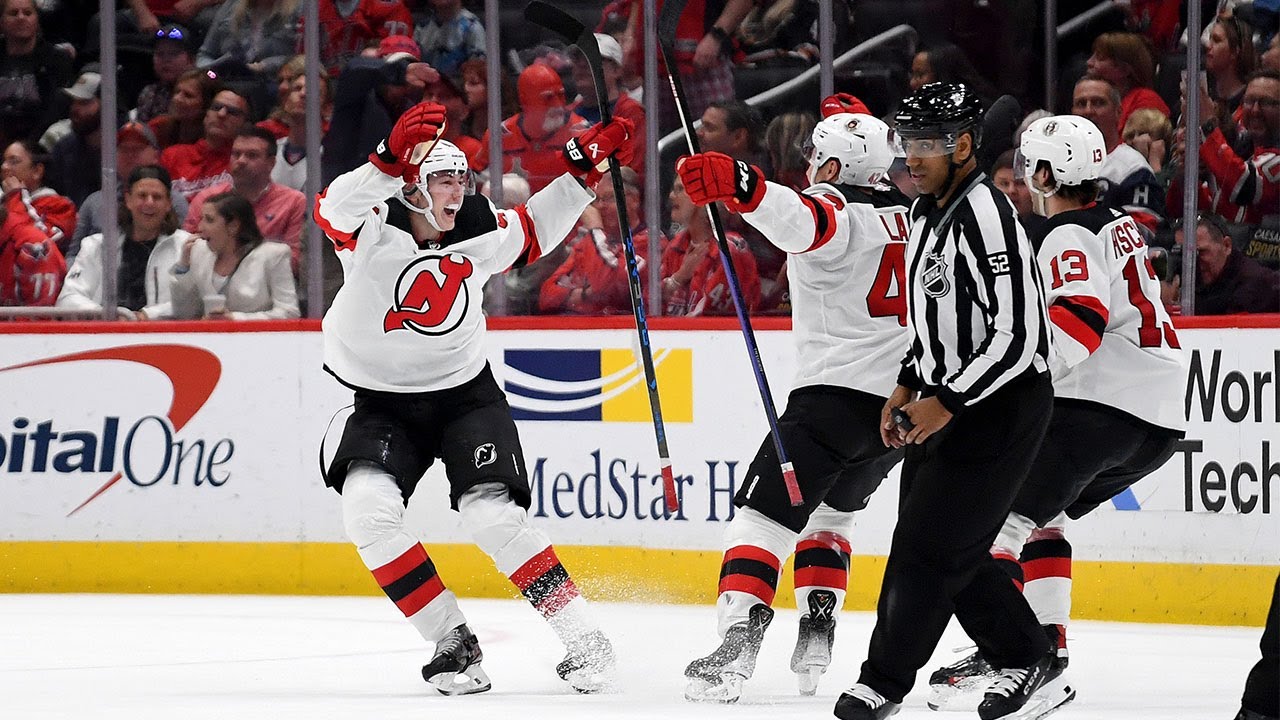 New Jersey Devils' Dougie Hamilton (7) cross-checks Carolina