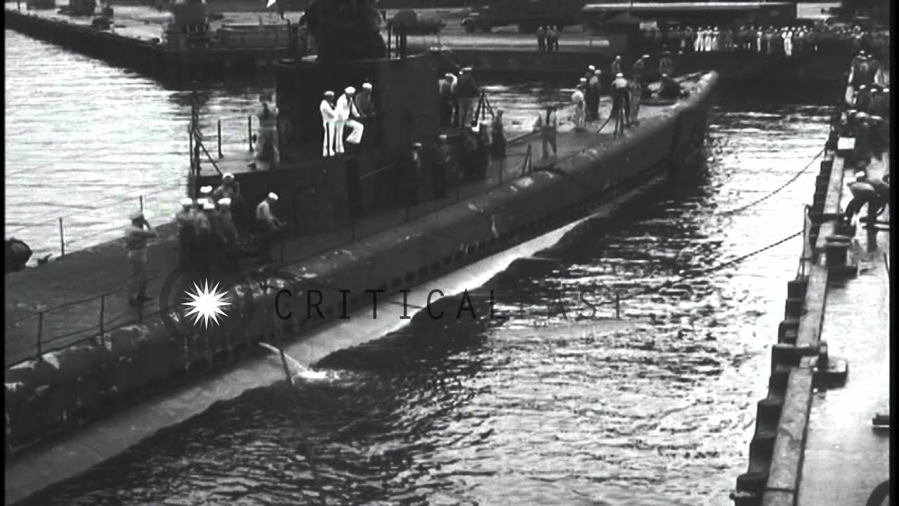 Sailors cheering aboard USS Wahoo at the submarine base at Pearl Harbor