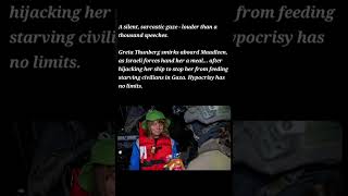 Greta Thunberg smirks aboard Maadleen, as Israeli forces hand her a meal.............