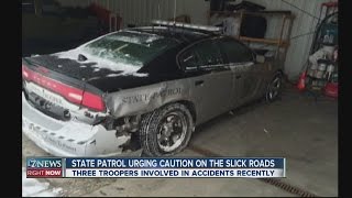 6 police cruisers hit by drivers on slick roads