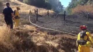 Fire crews mopping up small wild land fire on Highway 253 at mile marker 11.