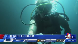 Diving into the warm water at the Homestead Crater in Midway, Utah