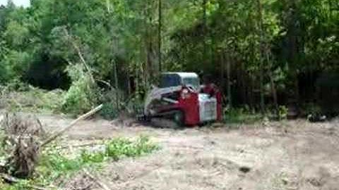 Skid steer pushing over trees