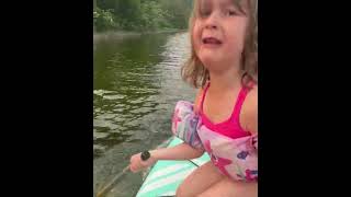 Daughter Shocked After Catching Bass While Paddle Boarding