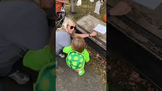 Guy hides in Halloween decoration coffin and scares little boy