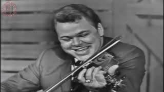 Roy Clark playing guitar, banjo and fiddle