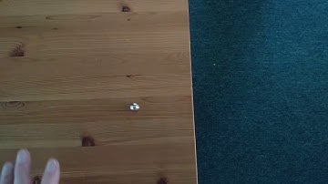 slow motion ball rolling on table